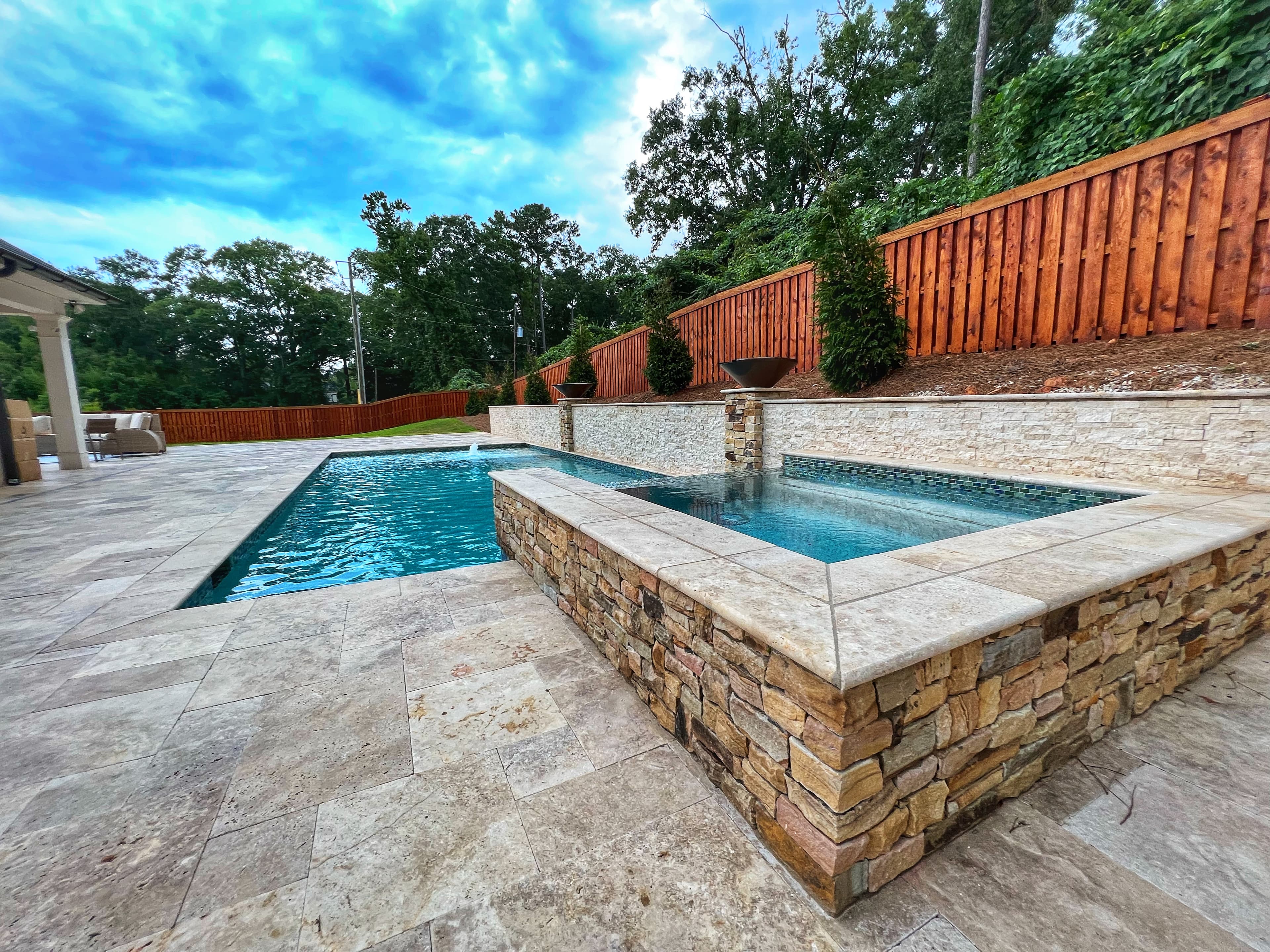 Stained privacy fence surrounding a pool area