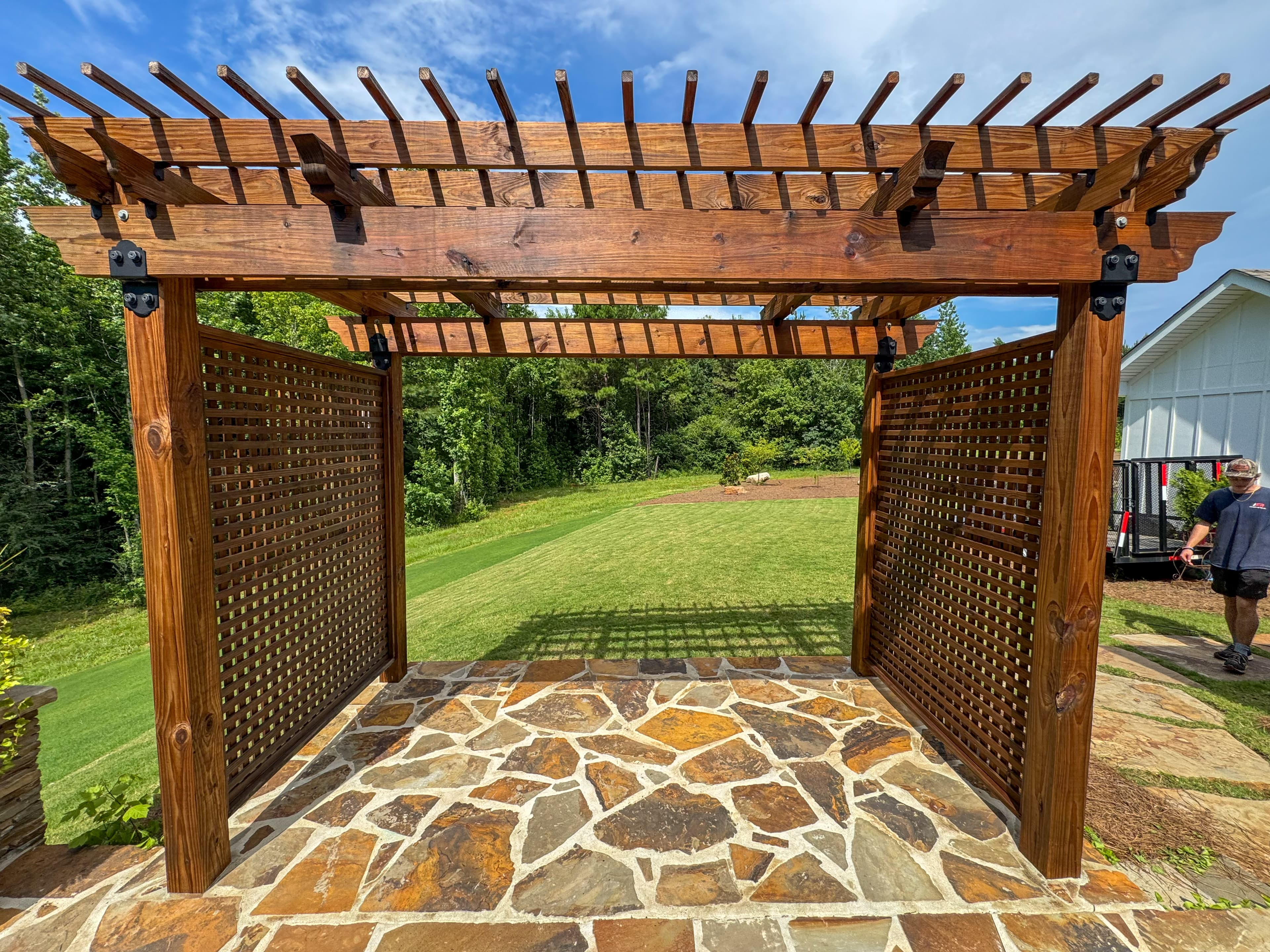 Stained pergola with lattice screens