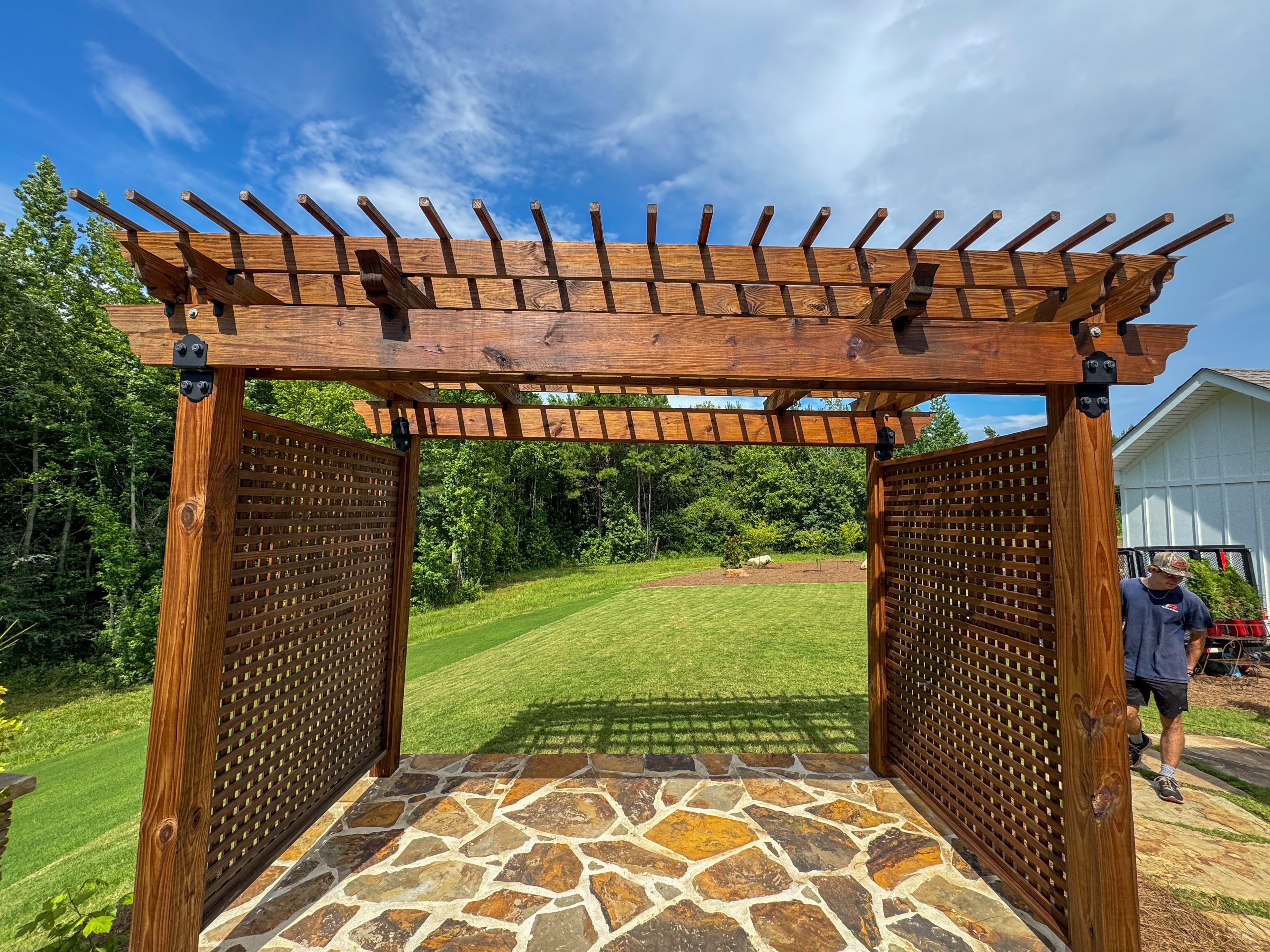 Stained pergola with lattice panels
