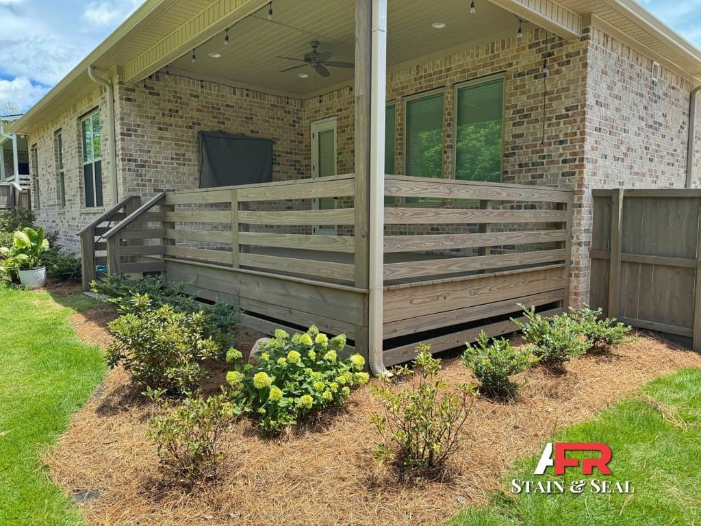 Horizontal porch railing stained in Cape Cod