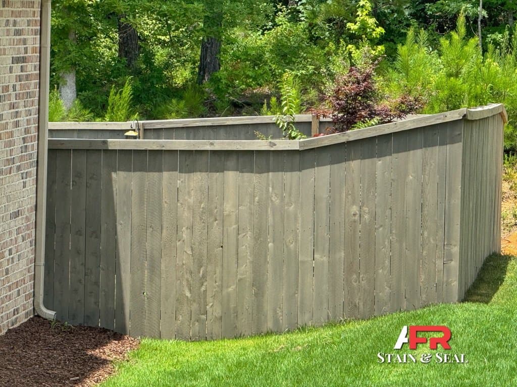 Curved privacy fence stained in Cape Cod