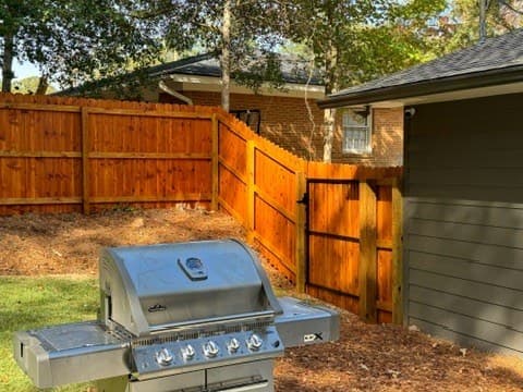 Backyard fence and gate stained in Cedar