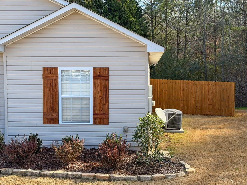Custom wood shutters and backyard fence stained in Pecan
