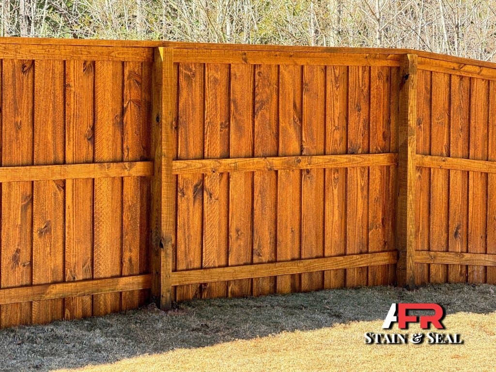 Board fence stained in Pecan