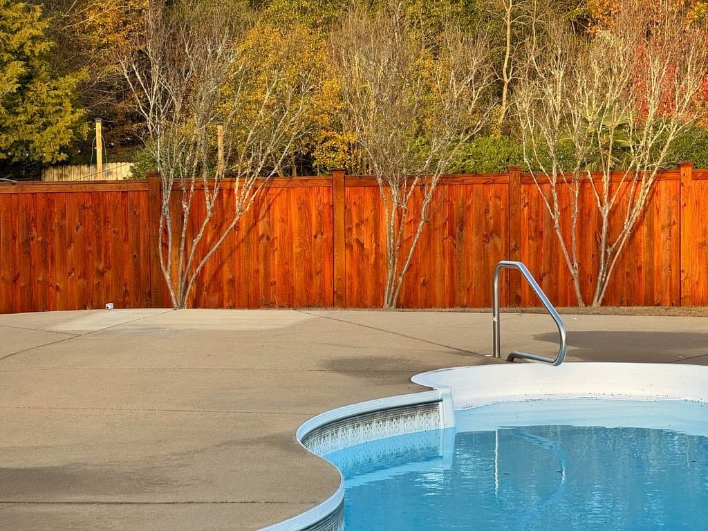 Poolside fence stained in Sequoia